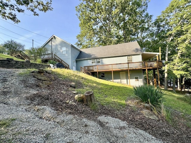 back of house with a wooden deck and stairs