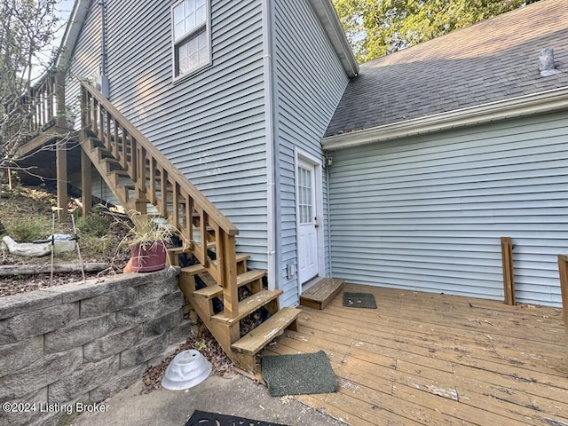 wooden deck featuring entry steps and stairway