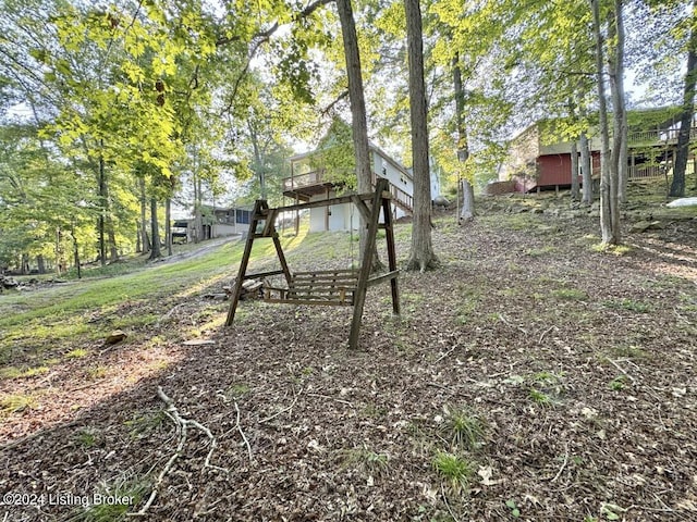 view of yard featuring stairs and a wooden deck