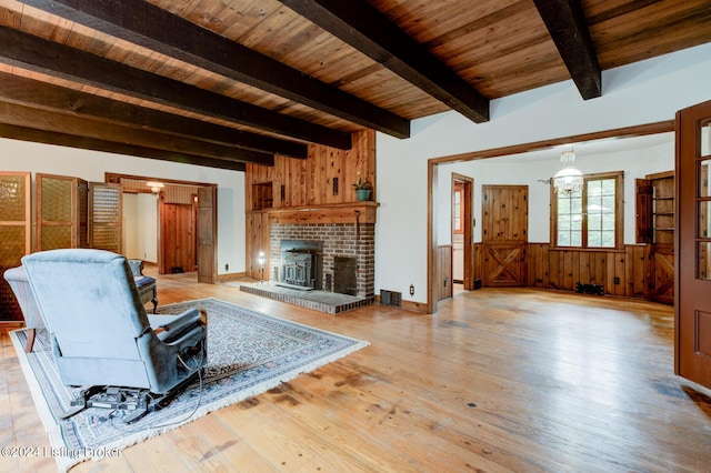 unfurnished living room with visible vents, beamed ceiling, wood ceiling, and light wood-style floors