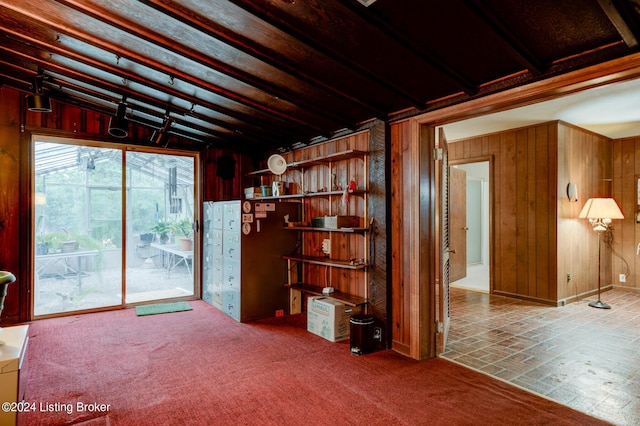 unfurnished living room with wooden walls