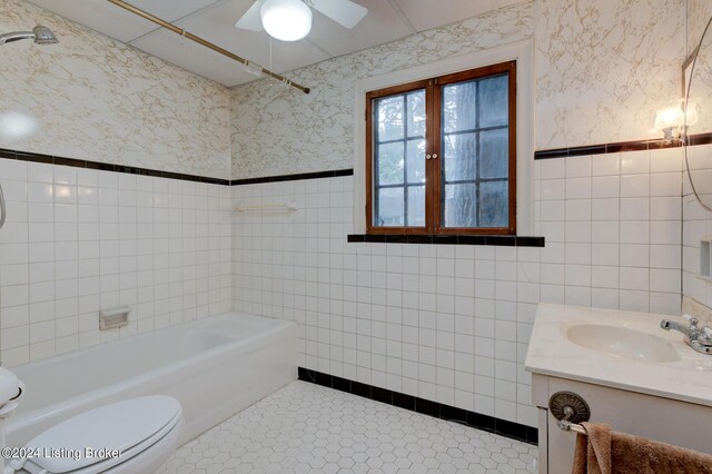 full bath featuring tile patterned flooring, toilet, wallpapered walls, and tile walls