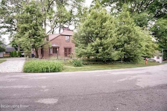 tudor house featuring brick siding