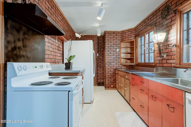 kitchen with white electric range, stainless steel countertops, under cabinet range hood, and brick wall