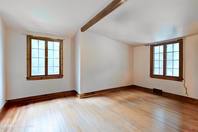 unfurnished room with plenty of natural light, visible vents, baseboards, and light wood-style floors