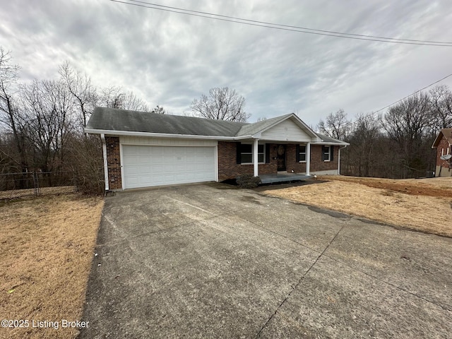 ranch-style home featuring a garage, brick siding, driveway, and a porch