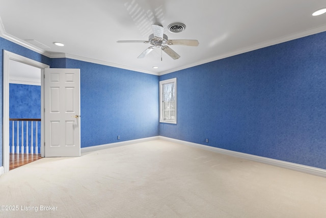 carpeted empty room with visible vents, crown molding, baseboards, recessed lighting, and a ceiling fan