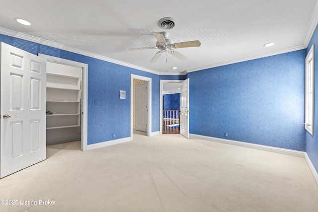 unfurnished bedroom with crown molding, carpet flooring, visible vents, and baseboards