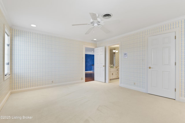 unfurnished bedroom with carpet, crown molding, and wallpapered walls