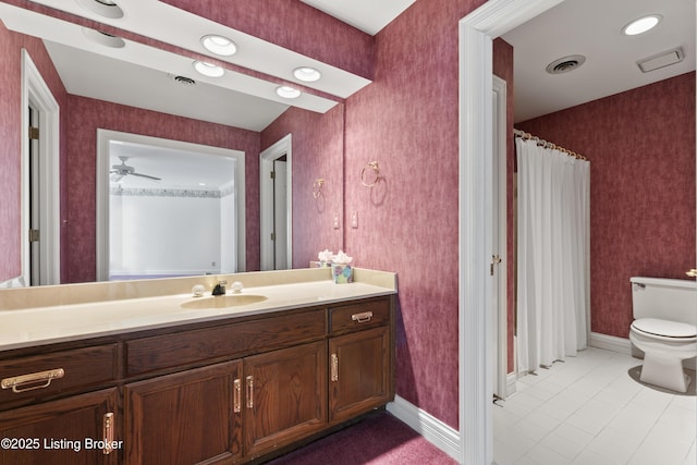 bathroom with visible vents, toilet, wallpapered walls, and vanity