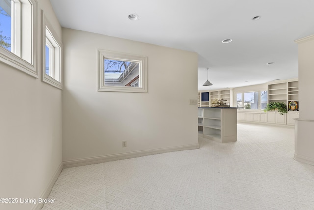 unfurnished living room featuring light carpet, recessed lighting, and baseboards