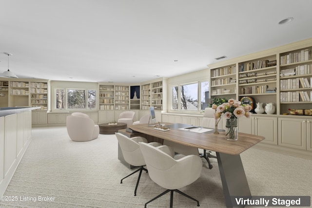 office area featuring built in shelves and visible vents