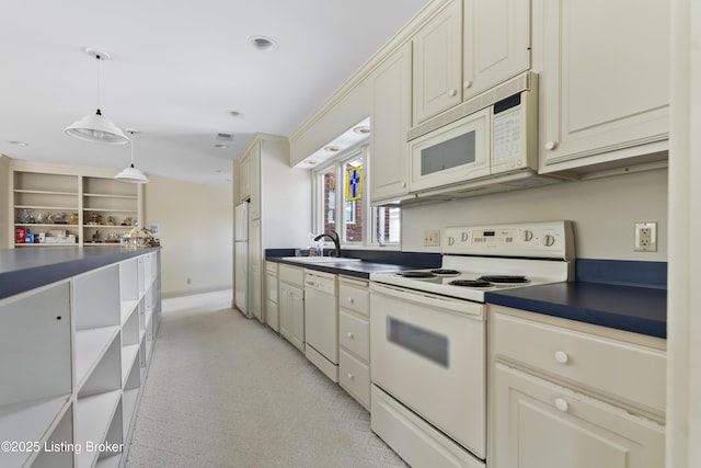 kitchen featuring white appliances, open shelves, a sink, dark countertops, and decorative light fixtures