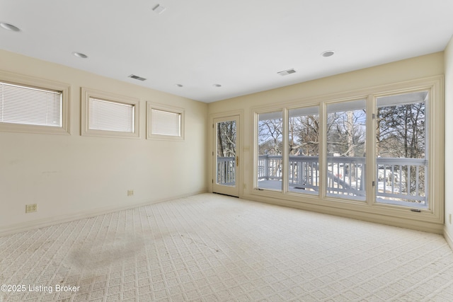 empty room featuring visible vents, recessed lighting, baseboards, and carpet floors