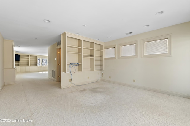 unfurnished living room with recessed lighting, visible vents, baseboards, and carpet