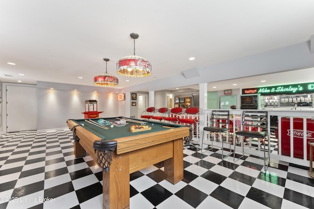 game room with a bar, tile patterned floors, recessed lighting, and ornate columns