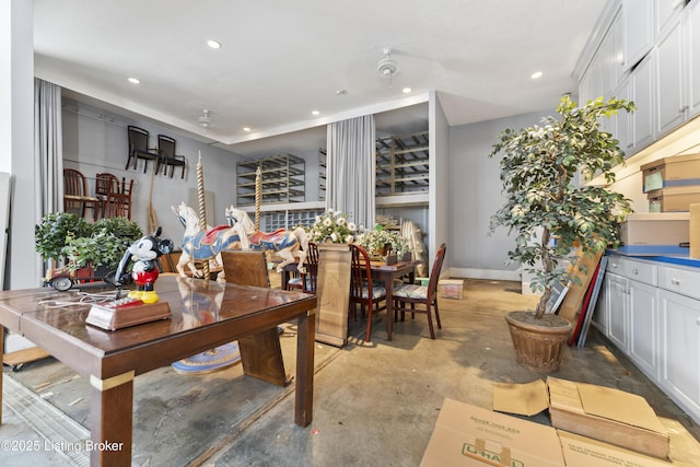 dining room with recessed lighting, baseboards, and concrete flooring