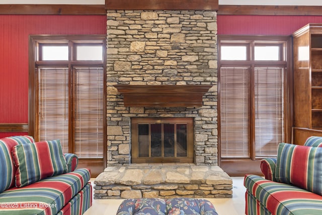 living room featuring a stone fireplace