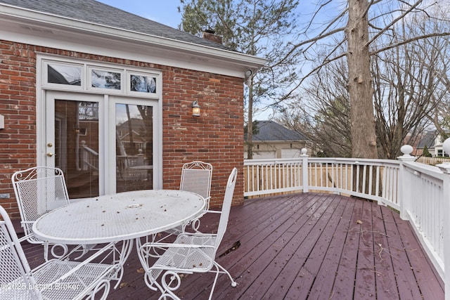 wooden terrace featuring outdoor dining space