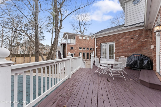 wooden deck with fence and grilling area