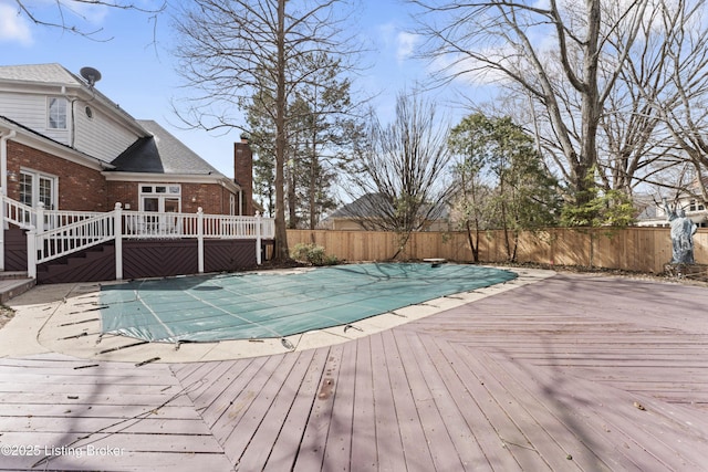 view of pool with a deck, fence, and a fenced in pool