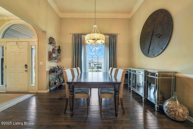 dining room with baseboards, crown molding, an inviting chandelier, and hardwood / wood-style floors