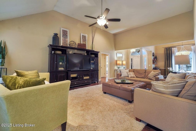 living area featuring high vaulted ceiling and a ceiling fan