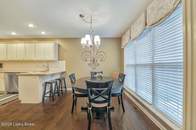 dining area with recessed lighting, baseboards, an inviting chandelier, and dark wood-style flooring