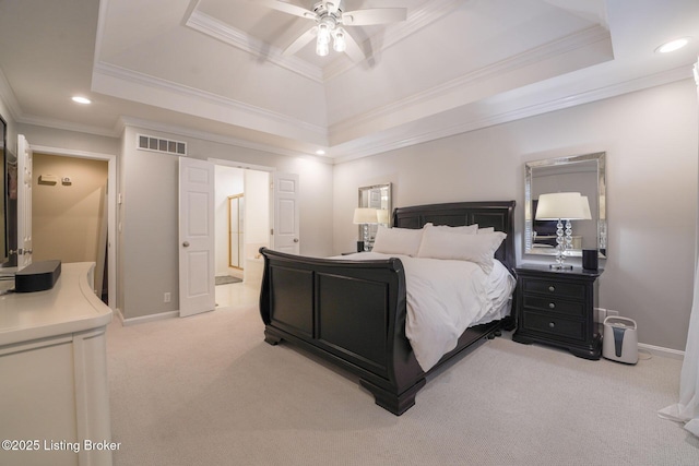 bedroom featuring baseboards, visible vents, a raised ceiling, and light carpet