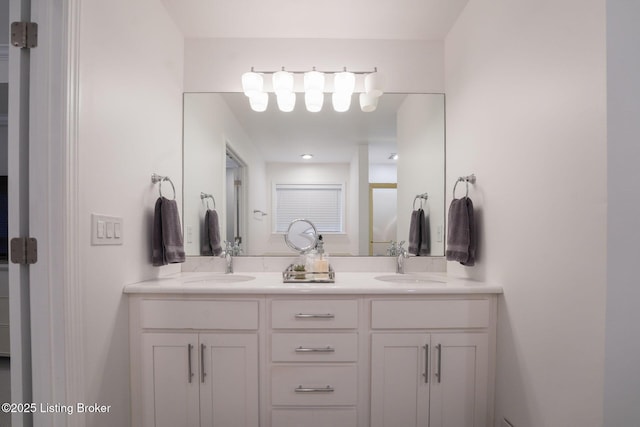 bathroom featuring a sink and double vanity