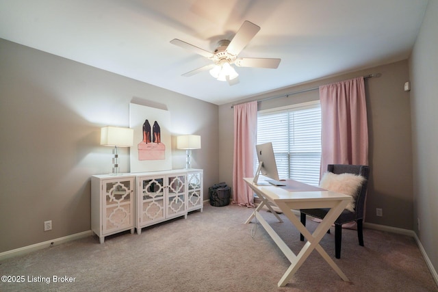 office space featuring baseboards, carpet, and a ceiling fan