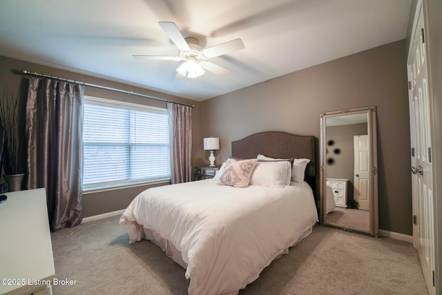 bedroom with light colored carpet, baseboards, and ceiling fan