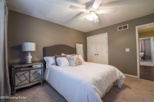 carpeted bedroom featuring baseboards, visible vents, a closet, and ceiling fan