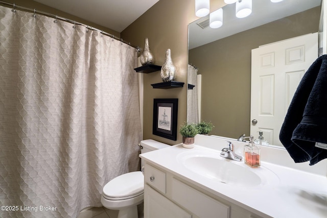 bathroom featuring visible vents, toilet, and vanity