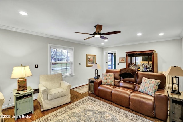 living area with ornamental molding, recessed lighting, wood finished floors, and baseboards