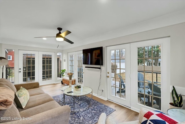 living room with french doors, recessed lighting, ceiling fan, wood finished floors, and baseboards