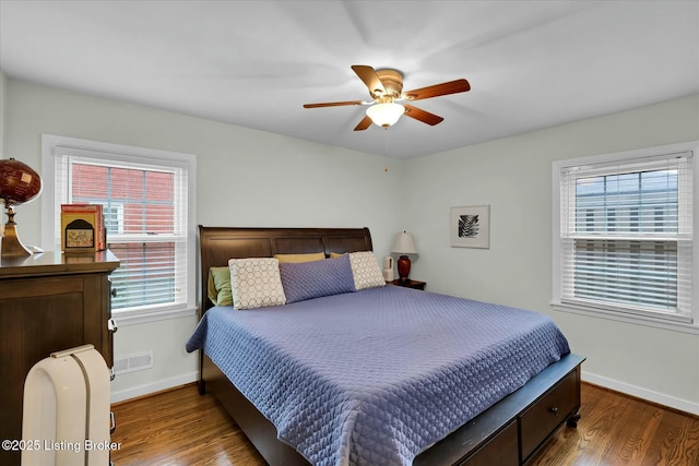 bedroom featuring multiple windows, wood finished floors, and visible vents