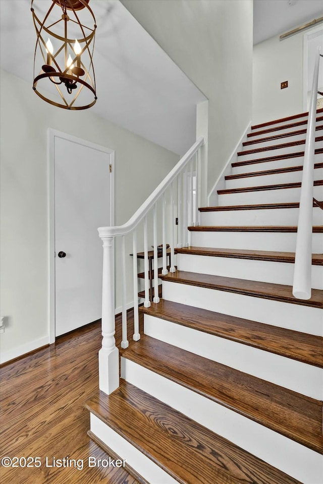 stairs with baseboards and wood finished floors