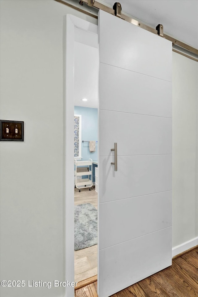 interior space featuring a barn door and wood finished floors