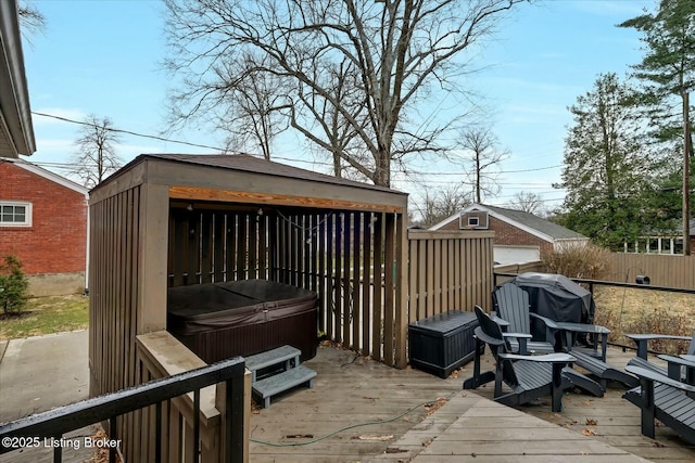 wooden terrace with fence, a grill, and a hot tub