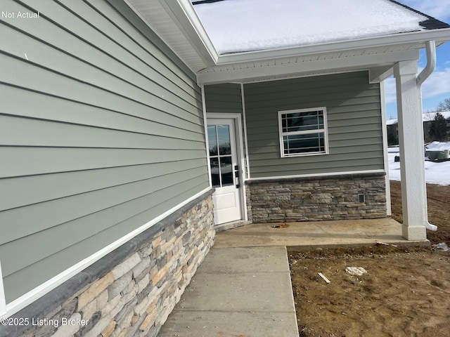 view of exterior entry with stone siding