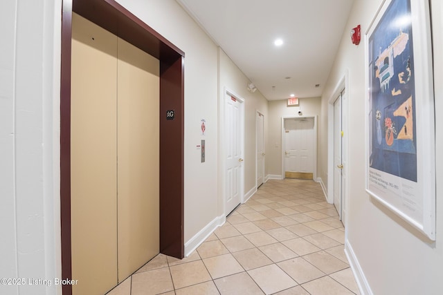 hall with elevator, recessed lighting, baseboards, and light tile patterned flooring