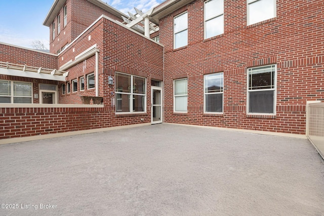 exterior space featuring a patio area and brick siding