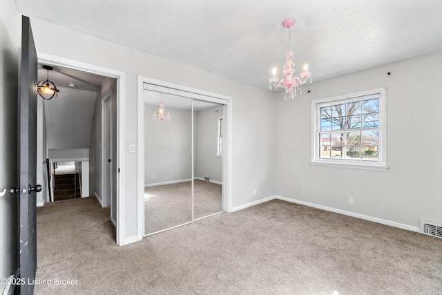 unfurnished bedroom featuring carpet, a closet, visible vents, and baseboards