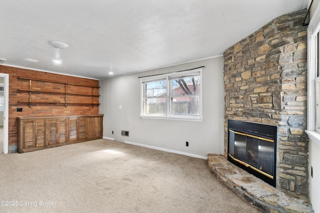 unfurnished living room featuring visible vents, a fireplace, baseboards, and carpet flooring