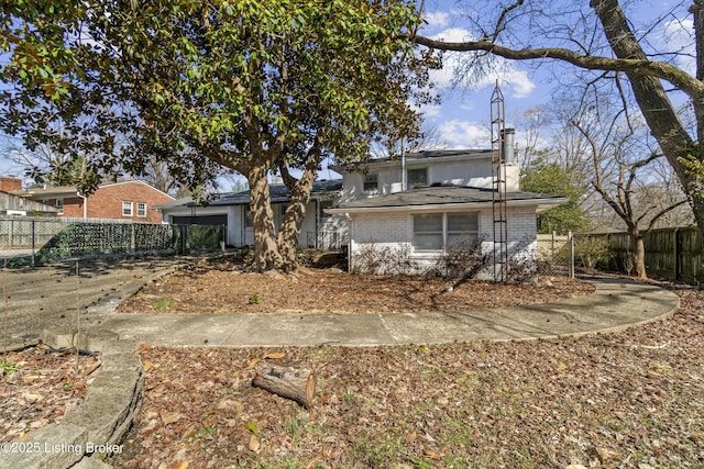 back of house with fence and brick siding