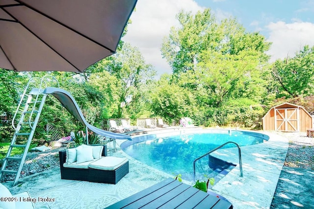 view of swimming pool featuring a fenced in pool, a patio, a storage unit, a water slide, and an outdoor structure