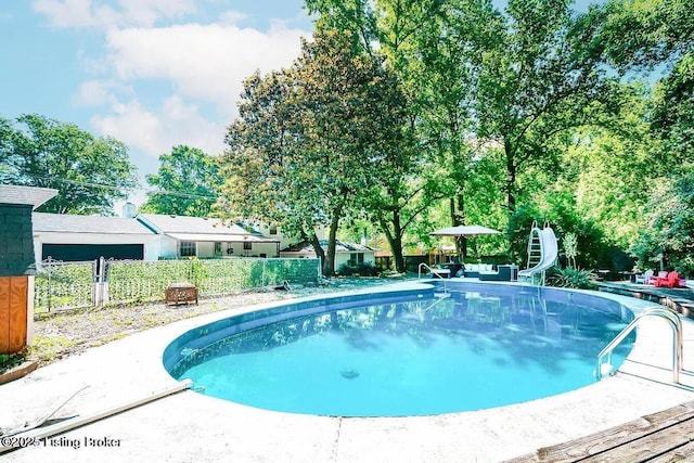 view of pool with fence and a patio