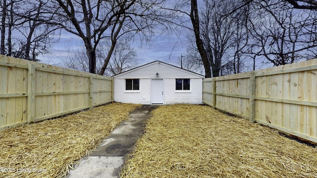 exterior space featuring a fenced backyard and an outdoor structure