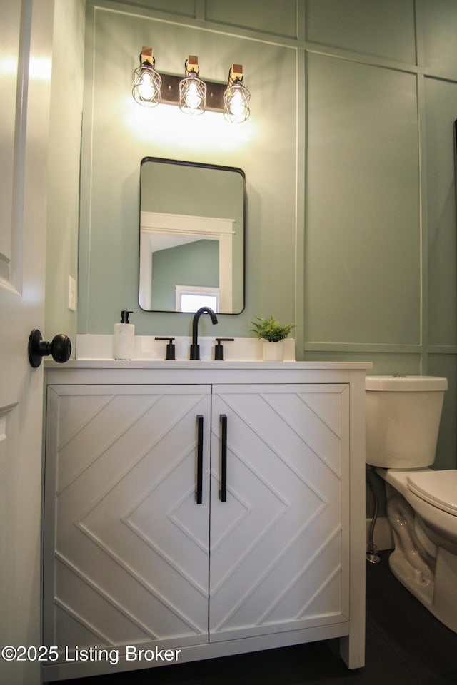 bathroom with vanity and toilet